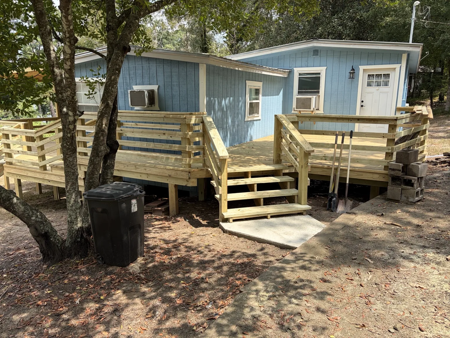 Finished blue house with rear deck and stairs by Davco Designz