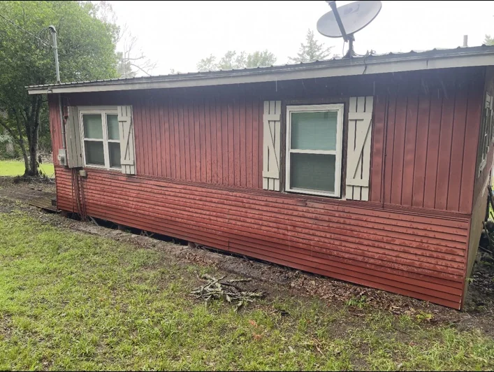 Red house exterior before Davco Designz work