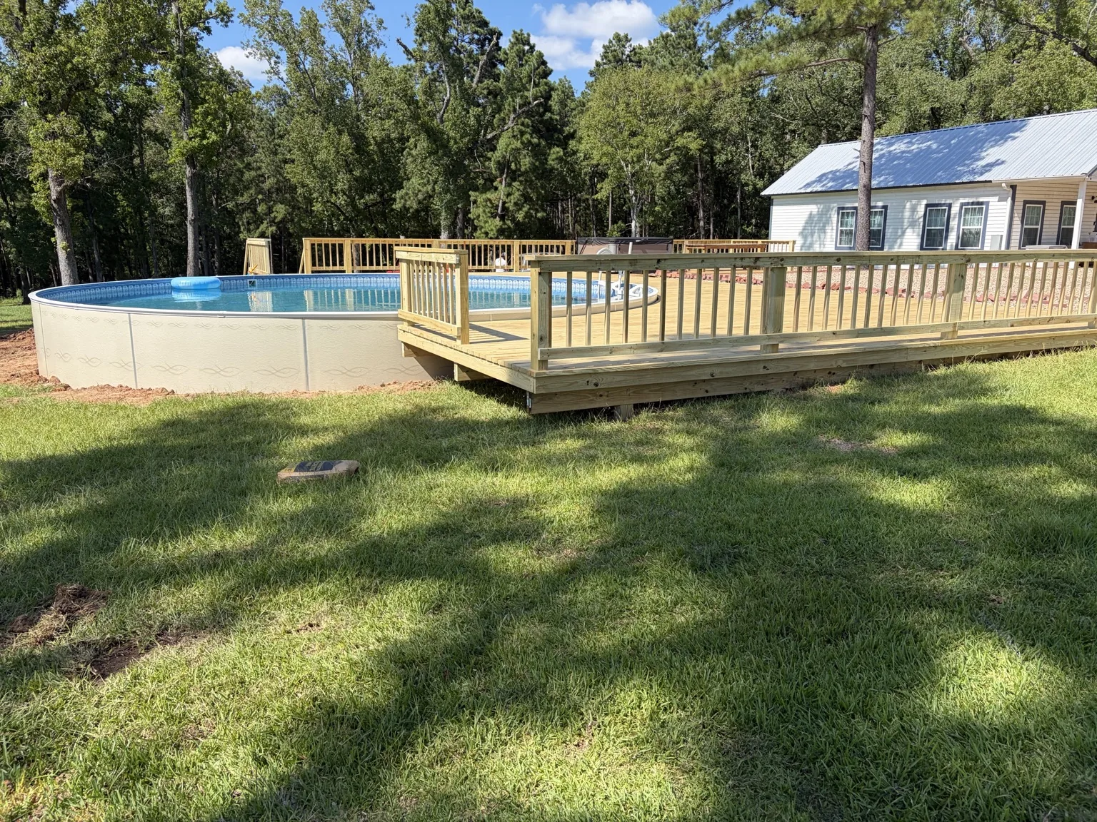 Completed above-ground pool deck by Davco Designz